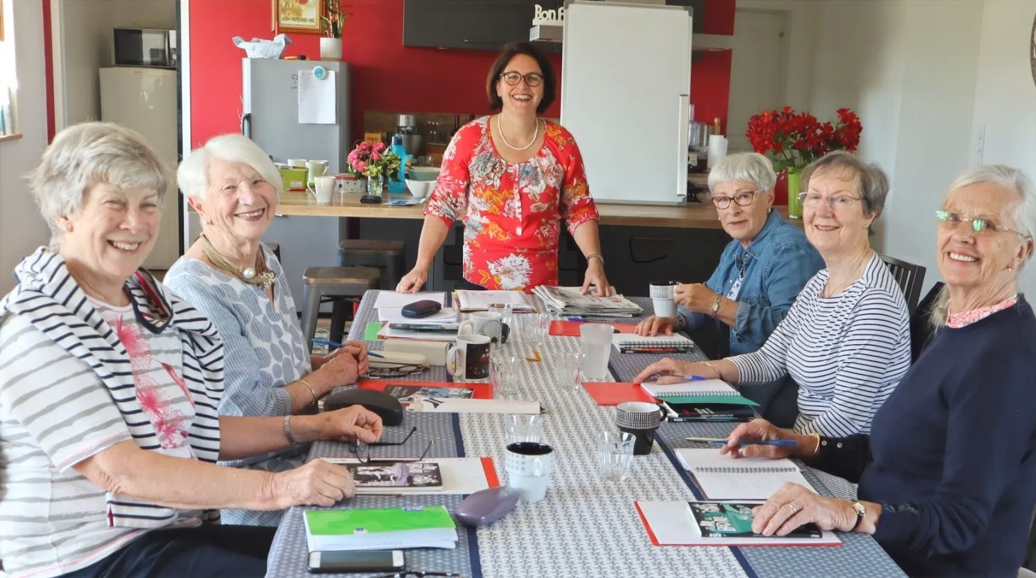 Flo donnant un cours à un groupe d'invités autour de la table du gîte